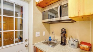 A kitchen with a stainless steel sink, a coffee maker, and a microwave. - Mtn Cabin 1 Mi to Tiec: Outdoor Kitchen + Fire Pit (Mill Spring)