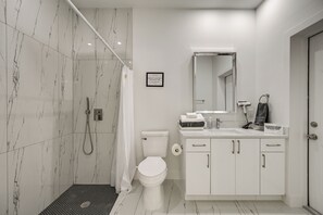 A modern bathroom with a shower, toilet, and vanity. - Near Golf & Spring Training: Lehigh Acres Retreat (Lehigh Acres)