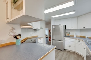 A modern kitchen with white cabinets, a stainless steel refrigerator, and a grey countertop. - Stunning Mountain Views! Secluded Retreat in Bend (Bend)