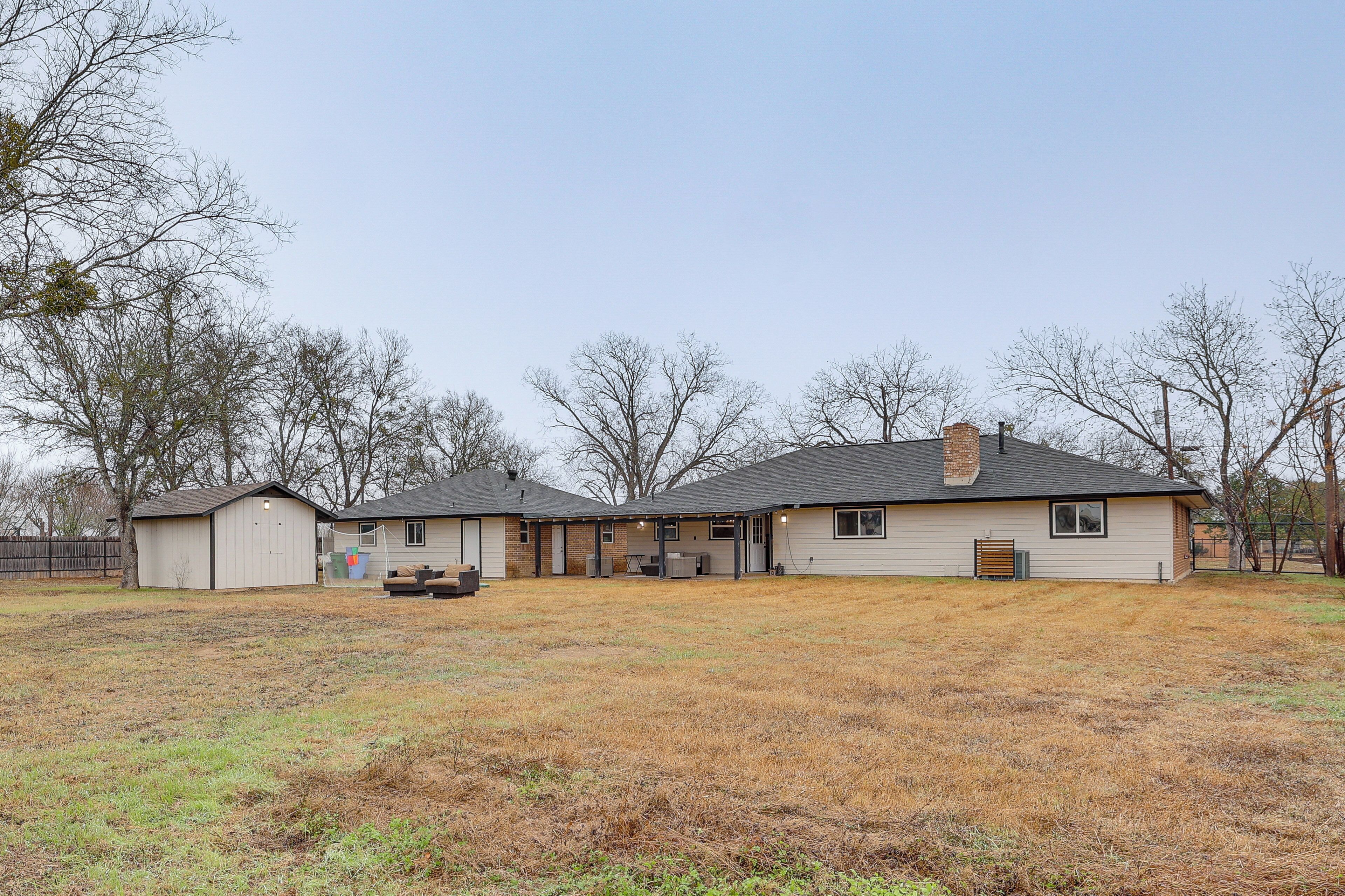 A single-story house with a covered patio and a detached garage.