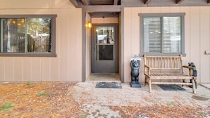 A wooden bench outside a building with a door and windows. - Nat'l Forest Retreat at 'the Nest at Pinetop' (Pinetop)