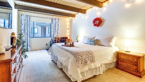 A cozy bedroom with a large bed, wooden nightstand, and a dresser. - Nat'l Forest Retreat at 'the Nest at Pinetop' (Pinetop)