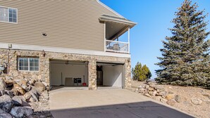 A two-story house with a stone facade, a covered porch, and a garage. - Family & Group Friendly! Hilltop Cedar City Home (Cedar City)