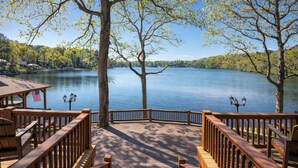 A wooden deck with benches overlooking a lake, a flag, and a lamp post. - 2-tier Dock! Jordan Lake Family Retreat (Titus)