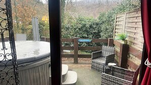 A hot tub area with wicker furniture and a wooden fence labeled "JACUZZI". - Dog-friendly House With Sauna, Bubble Bath (Bouillon)
