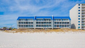 A beachfront hotel with multiple balconies and a blue roof. - Regatta Condominiums 106b 3 Bedroom Condo (Gulf Shores)