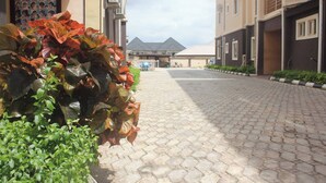 A paved pathway leading to a building with a gated entrance.