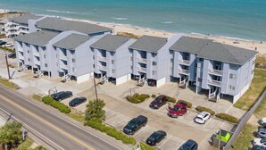 A beachfront hotel with multiple balconies, parking, and a view of the ocean. - Sea Colony #35B - Sunrise Balcony +  Community Pool (Carolina Beach)