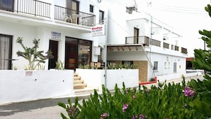 A two-story building with a sign for 'MilouNapa Tourist Apartments'. - G Papanicola Tourist Apartments (Ayia Napa)