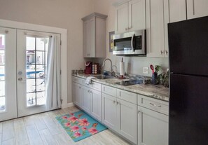 Cabin, 1 King Bed, Patio, Pool View (Tank House) | Private kitchen - Tank House Stay for 2 - Access to Pool, Hot Tub (Comfort)