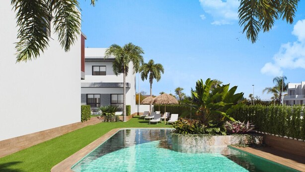 A modern pool area with a clear pool, surrounded by well-maintained grass and palm trees. - Benoa Zen Ground-floor luxury, direct pool access, by Oyoostays (Pilar de la Horadada)