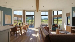 A spacious living area with a large window offering a view of a green landscape. - Wansfell, Whitbarrow (Penrith)