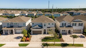 A residential area with multiple two-story houses, each with a garage and a driveway. - Last Minute Disney Getaway! Luxury Villa with Private Pool, Game Room & Themed Bedrooms. Book Now! #161617 (Orlando)