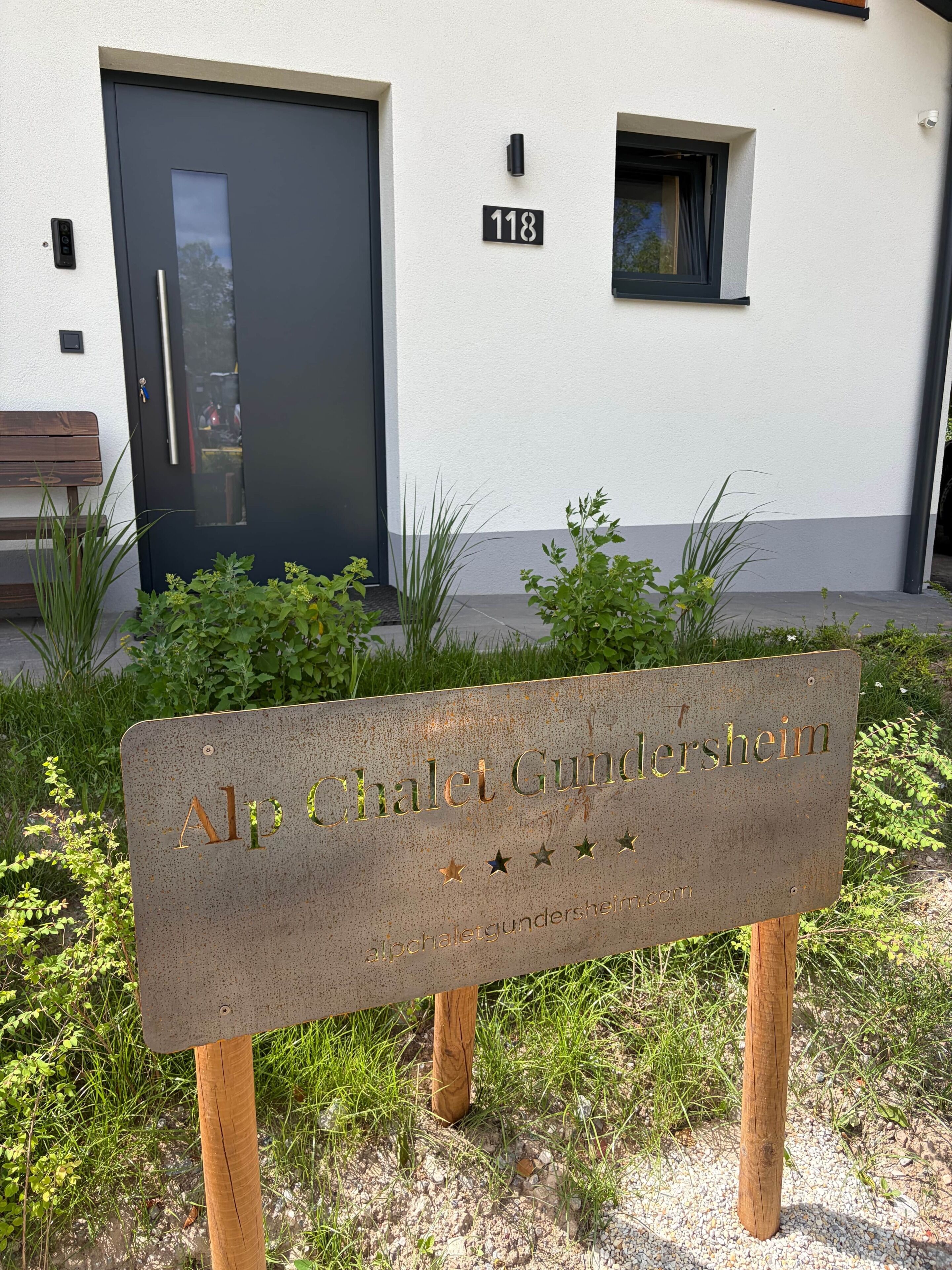 A sign with the name 'Alp Chalet Gundersheim' and a website address.