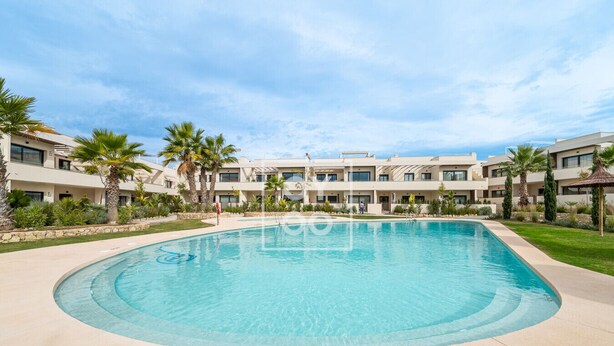 A swimming pool surrounded by a modern building with multiple balconies and palm trees. - Amalia Garden Groundfloor Retreat, a footstep from beach and sea, By OYOOSTAYS (Torrevieja)