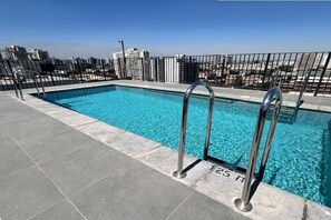 Outdoor pool - Family-Friendly Apartment • Walk to Parks & Shops • Safe and comfort for all. (Santiago)