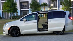 A white minivan with its door open, parked on a street. - Sunny Escape 1st Floor Near Disney & Universal (Kissimmee)