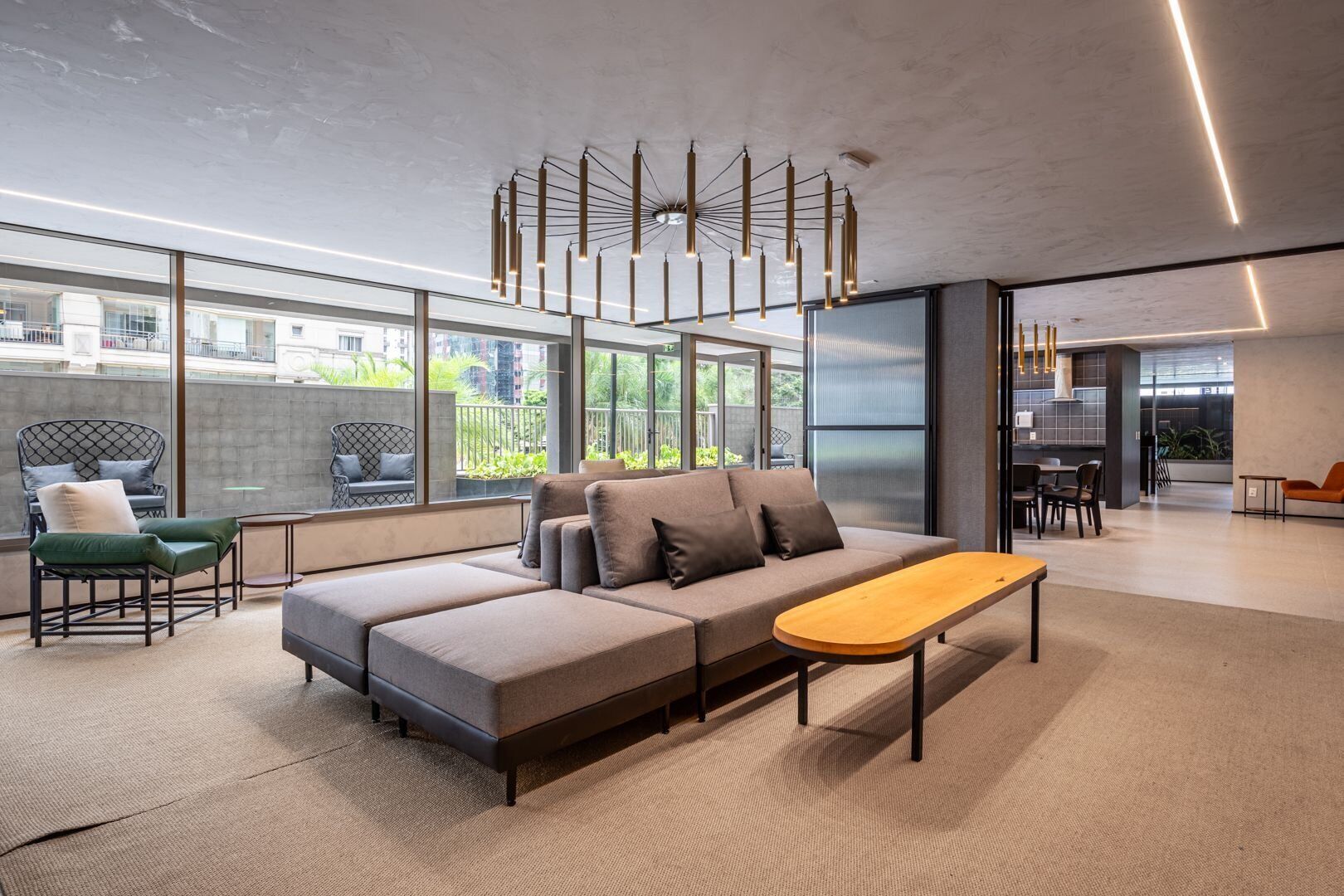 A modern living room with a sectional sofa, a wooden coffee table, and a unique ceiling light fixture.