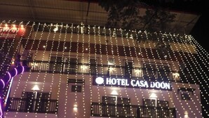 A hotel named "Hotel Casa Don" with multiple floors, string lights, and a festive entrance decorated for New Year 2026. - HOTEL CASA DOON (Dehradun)
