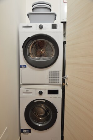 A stacked washer and dryer unit with a control panel and a 10-grit label. - La casa di Ari (Napoli)