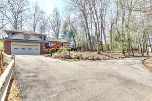 A residential house with a garage, a covered porch, and a driveway leading to the front door. - Luxury Fireplace Home, Deck & Views Near Biltmore (Asheville)