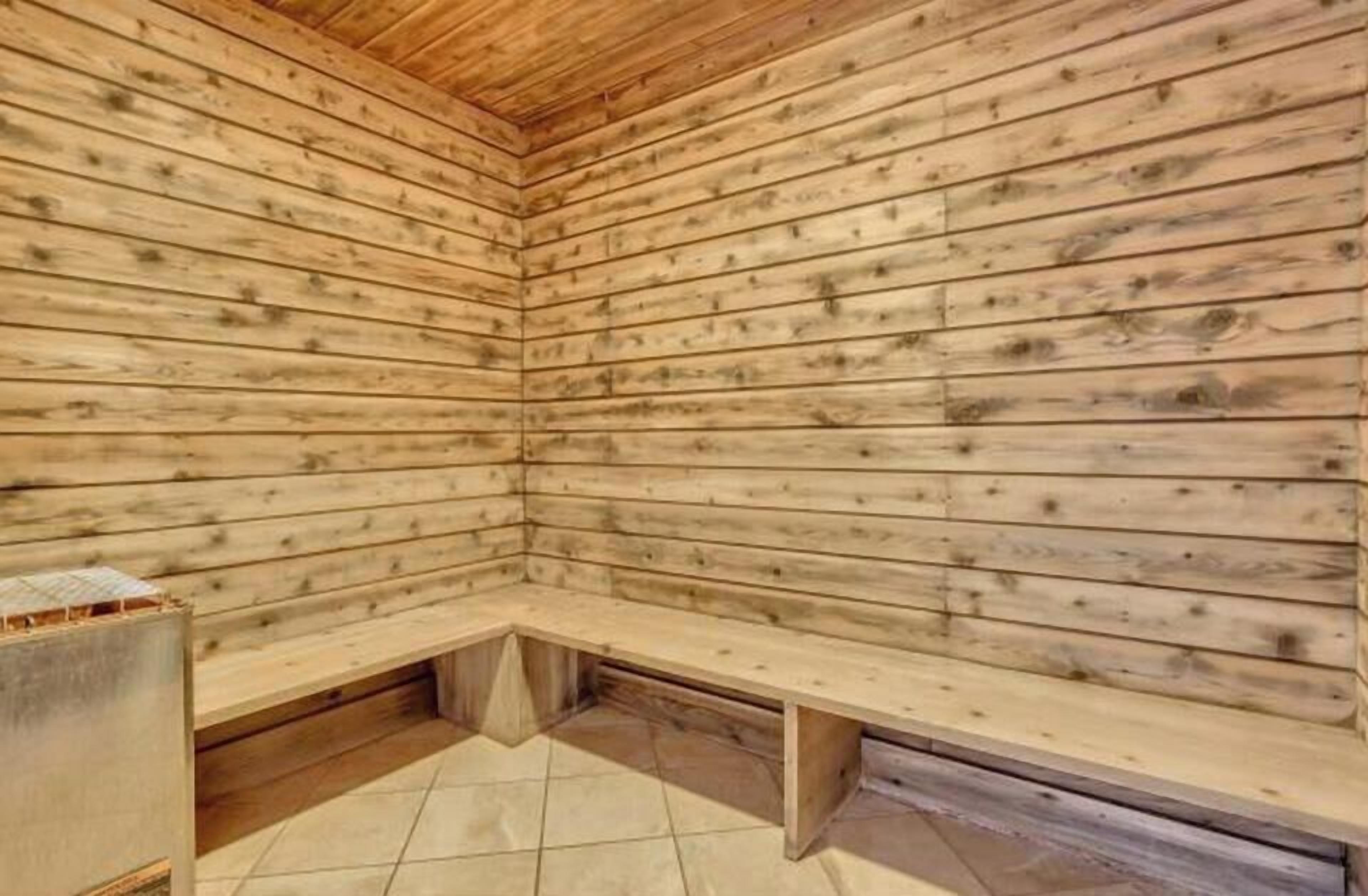A sauna room with wooden walls and benches.