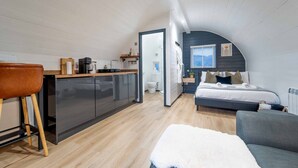 A compact, modern apartment with a kitchenette, a bedroom with a bed and a sofa, and a bathroom. - Apex Studio Pod & Jacuzzi Bath (Fort William)