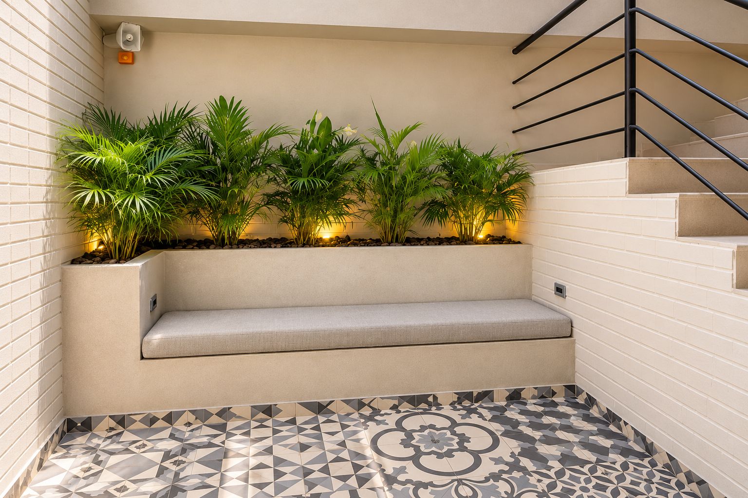 A corner seating area with a bench, potted plants, and a patterned floor.