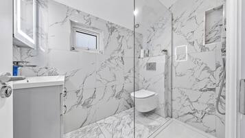 Shower, hair dryer, towels, toilet paper