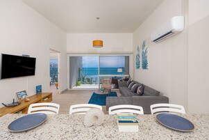 Apartment, Balcony, Sea View | Living area | 50-inch Smart TV with cable channels