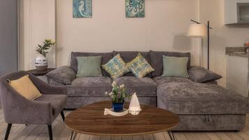 Apartment, Balcony, Sea View | Living area | 50-inch Smart TV with cable channels