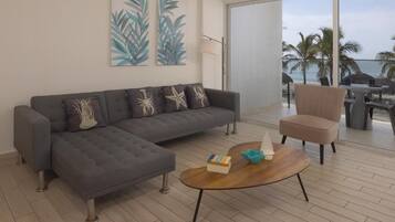 Apartment, Balcony, Sea View | Living area | 50-inch Smart TV with cable channels