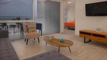 Apartment, Balcony, Sea View | Living area | 50-inch Smart TV with cable channels