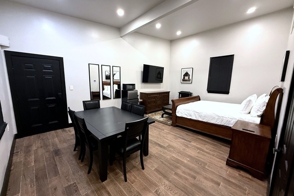 Open layout suite with Smart TV, refrigerator, and dedicated dining area.