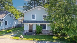 A two-story house with a front porch, a stone foundation, and a mailbox. - Lake View Lodge on Dewart Lake/1 mile from Blue Barn Berry Farm/kayaks! (Syracuse)