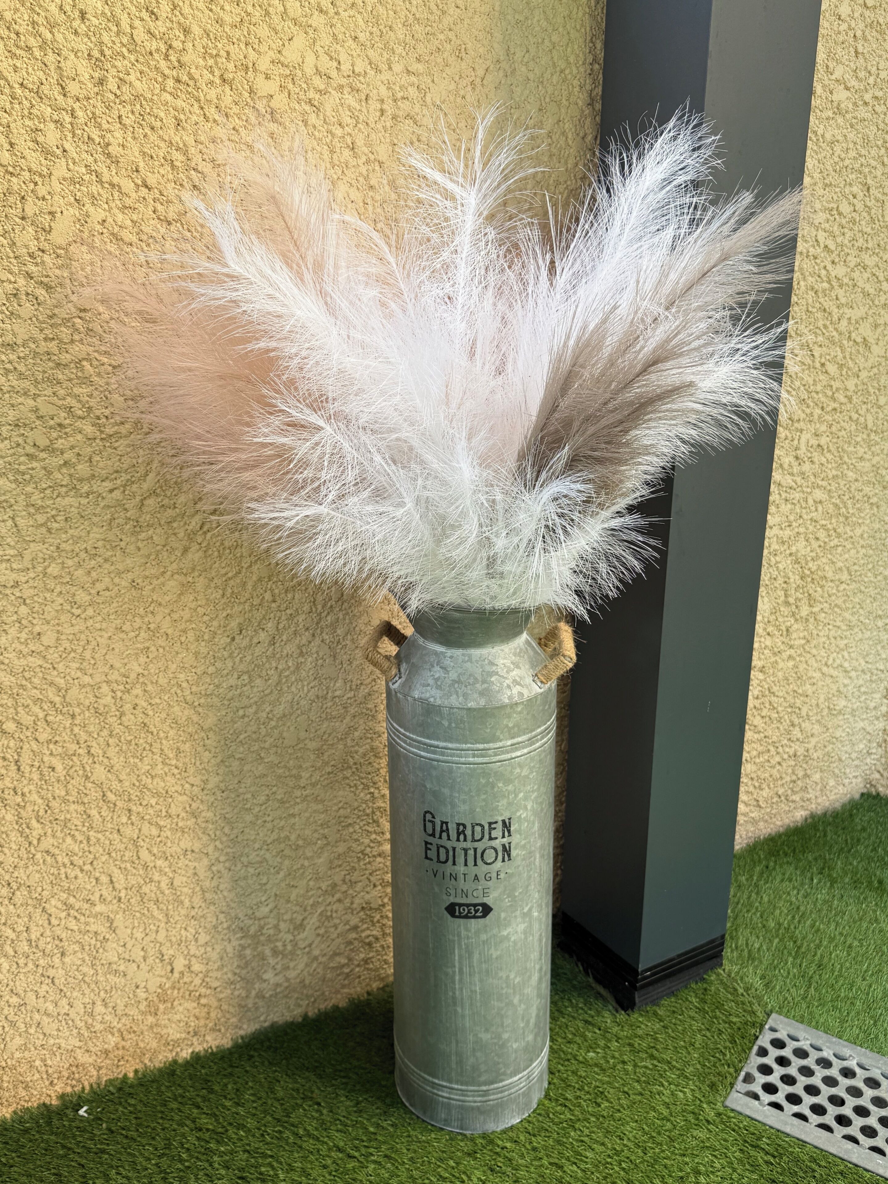 A metal container with a label 'Garden Edition Vintage Since 1932' and a white fluffy material inside.
