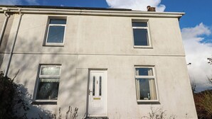 A two-story building with a white facade, a central door with glass panels, and multiple windows. - 4 Polgrain Turning (Bodmin)