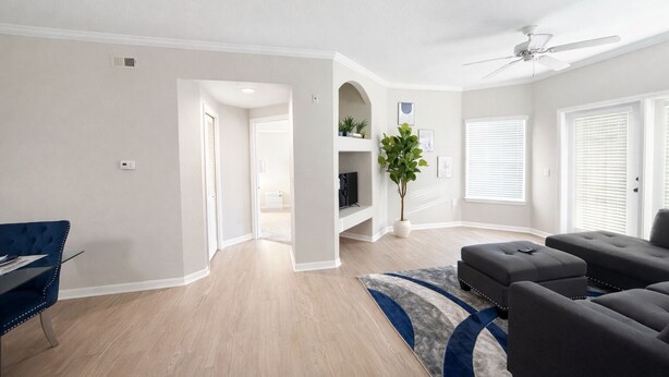 A modern living room with a dark grey sofa, a glass coffee table, and a blue accent rug. - 5-STAR Sarasota Stay Luxur 2BR/2BA (Sarasota)