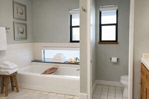 A bathroom with a bathtub, a toilet, and a window. - 10 minutes to Sequoia Park Entrance/Hot Tub/Fire Pit/Pet Friendly/Mountain Views (Three Rivers)