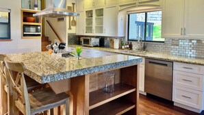 A modern kitchen with granite countertops, stainless steel appliances, and white cabinetry. - 10 minutes to Sequoia Park Entrance/Hot Tub/Fire Pit/Pet Friendly/Mountain Views (Three Rivers)
