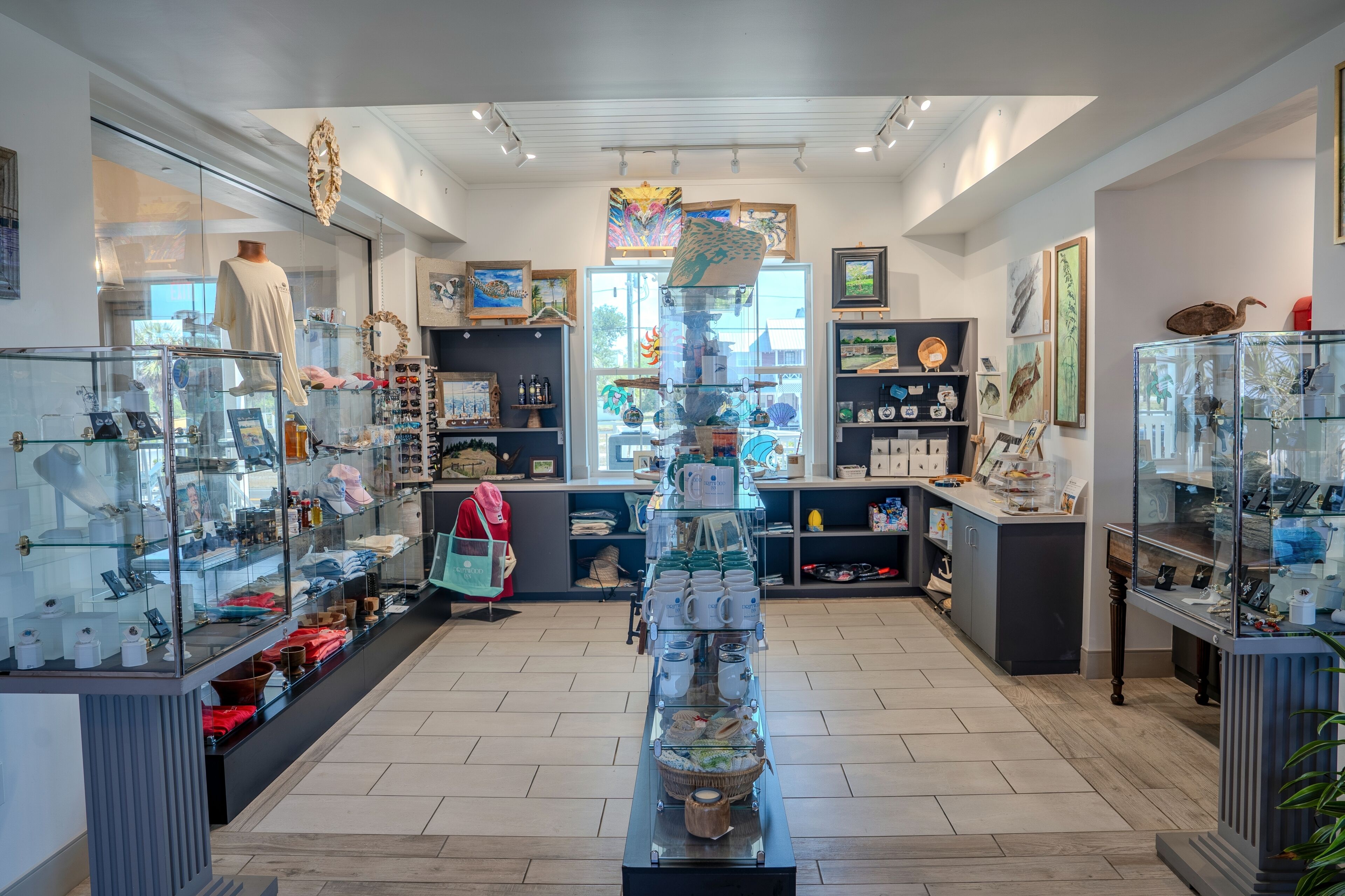 A well-lit store with glass display cases and shelves filled with various items.