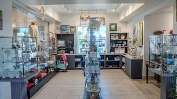 A well-lit store with glass display cases and shelves filled with various items.