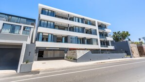 A modern multi-story building with large windows and a flat roof. - Alto Livello 304 - One Bedroom Apartment, Sleeps 2 (Cape Town)