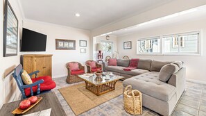 A living room with a sofa, chairs, a coffee table, and a television. - Oceanfront Atelier by Avantstay Beachfront Balboa Peninsula Escape (Newport Beach)
