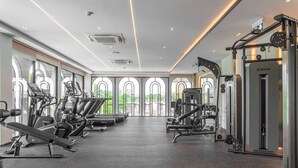 Et fitnesscenter med løbebånd, træningsmaskiner og en squat-station.