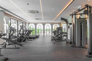 A gym with treadmills, weight machines, and a squat rack. - Suite Palma 1br the Title Ibg legendary bang tao (Choeng Thale)