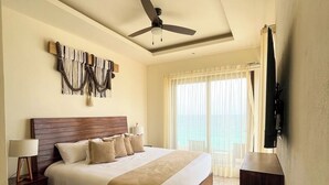 A bedroom with a bed, bedside tables, a ceiling fan, a wall-mounted TV, and a window with curtains. - Mr. W | Sophisticated Apartment in Torre Marsai (Punta Negra)