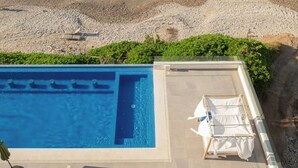 A swimming pool with a view of the beach and ocean. - Mr. W | Modern and Stylish 1BR in Torre Marsai (Punta Negra)