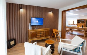 A living room with a TV, wooden furniture, and a dining area. - Beautiful home in Otocac (Otocac)