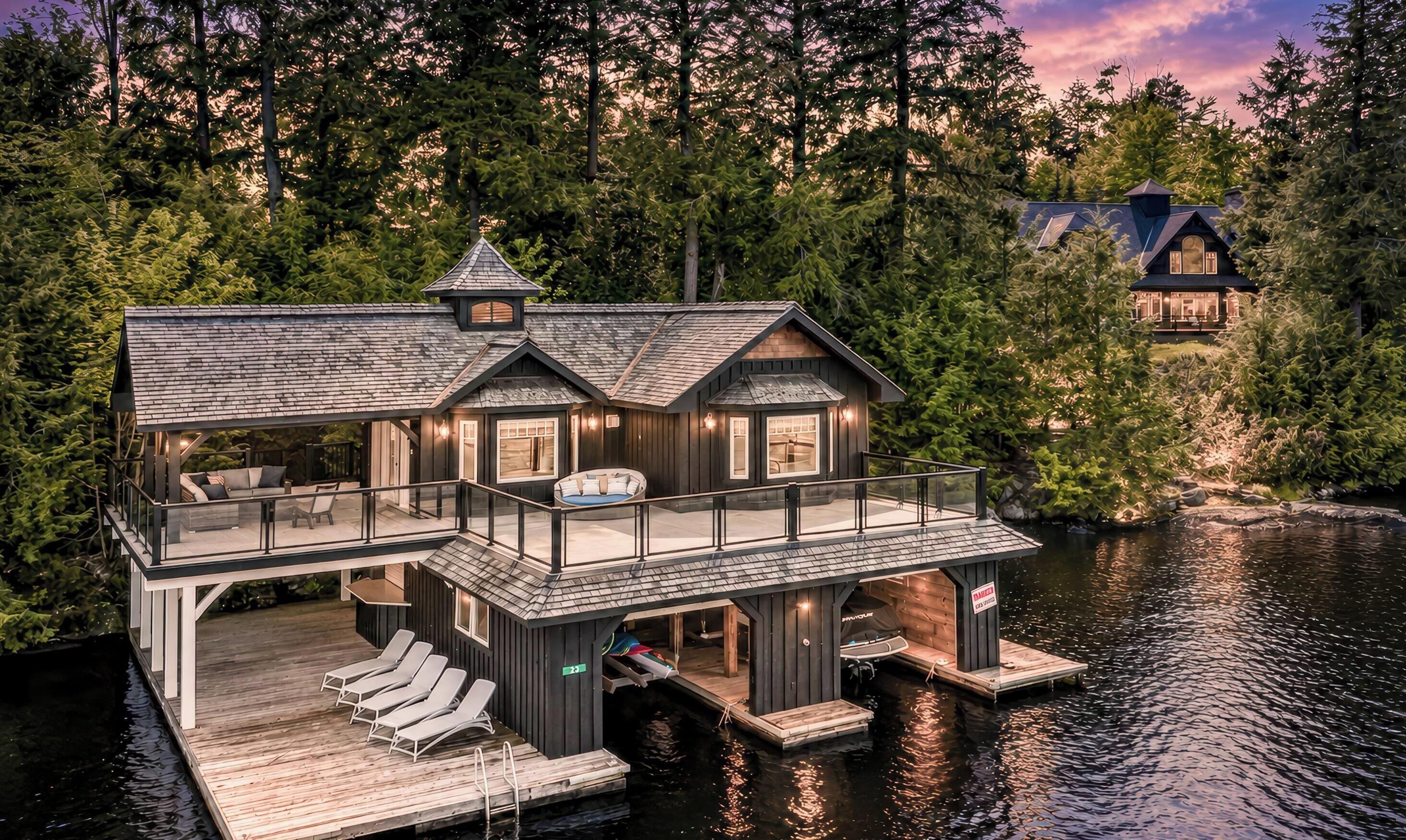 A lakeside cabin with a deck, outdoor seating, and a boat dock.